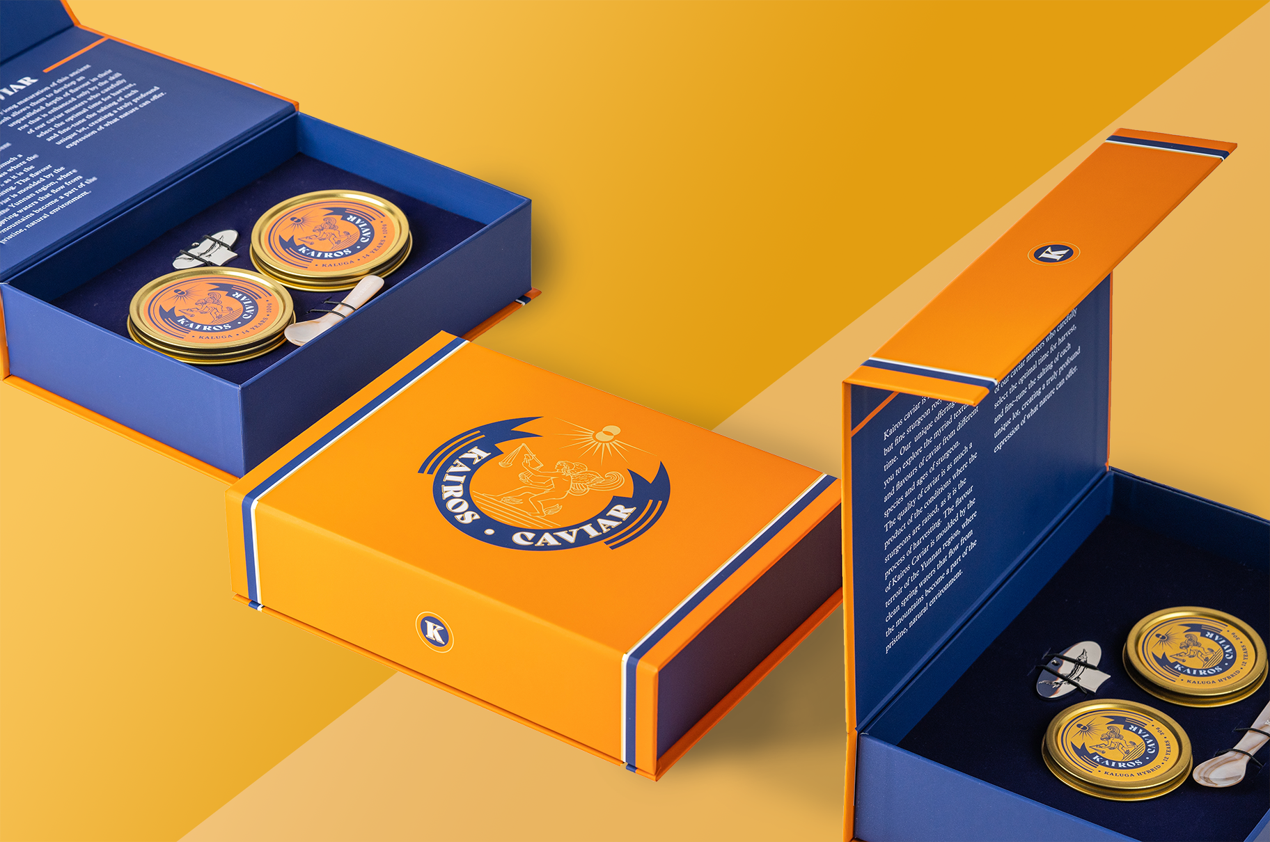 Kairos Caviar packaging suite — orange and navy magnetic gift boxes opened to reveal gold caviar tins and mother-of-pearl spoons, on a yellow backdrop